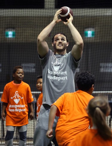 Calgary Stampeders linebacker Alex Singleton catches a pass from a student during a Jumpstart event at the RBC Convention Centre that is part of CFL Week in Winnipeg on Thurs., March 22, 2018. Over 150 kids from Greenway and Victory schools were able to participate in drills with current CFL stars. Kevin King/Winnipeg Sun/Postmedia Network