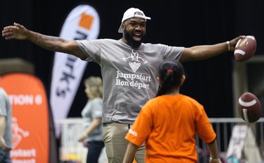 Hamilton Tiger-Cats linebacker Simoni Lawrence does a celebration dance with a student during a Jumpstart event at the RBC Convention Centre that is part of CFL Week in Winnipeg on Thurs., March 22, 2018. Over 150 kids from Greenway and Victory schools were able to participate in drills with current CFL stars. Kevin King/Winnipeg Sun/Postmedia Network