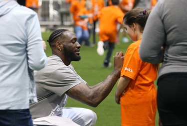 Saskatchewan Roughriders defensive lineman Willie Jefferson autographs a student's shirt during a Jumpstart event at the RBC Convention Centre that is part of CFL Week in Winnipeg on Thurs., March 22, 2018. Over 150 kids from Greenway and Victory schools were able to participate in drills with current CFL stars. Kevin King/Winnipeg Sun/Postmedia Network