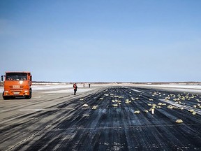 A handout picture provided by YakutiaMedia news agency shows precious metal ingots on the runway of the airport of Yakutsk. A plane carrying a cargo of "precious metal" bars has dumped more than three tons on the runway of an airport following a problem with take-off in the eastern Siberian city of Yakutsk, local authorities said on March 15, 2018. (AFP PHOTO/YakutiaMedia/HO)