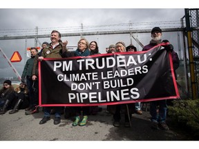 Federal Green Party Leader Elizabeth May, centre left, and NDP MP Kennedy Stewart, left, stand with protesters before they were arrested outside Kinder Morgan's facility in Burnaby, B.C., on Friday March 23, 2018. Protesters have been gathering all week - defying a court order - to protest the Kinder Morgan Trans Mountain pipeline expansion. The pipeline is set to increase the capacity of oil products flowing from Alberta to the B.C. coast to 890,000 barrels from 300,000 barrels.