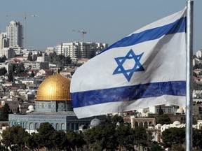 The Israeli flag flutters in front of the Dome of the Rock mosque and the city of Jerusalem, on December 1, 2017. THOMAS COEX/AFP/Getty Images