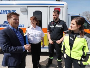 Minister of Infrastructure Ron Schuler (far left) talks with EMS operations supervisior for the IERHA Chris Ewacha, advanced EMS paramedic Bryan Collier and intermediate care paramedic Rebecca Clifton, just moments after the province announced the funding of 60 new full-time paramedic positions.