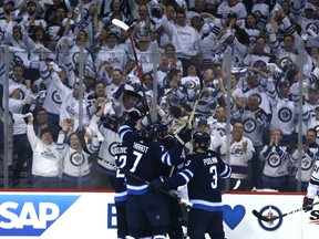 The Winnipeg Jets celebrate a goal from Brandon Tanev against the Minnesota Wild during Game 5 of their first-round NHL playoff series on Friday. (KEVIN KING/Winnipeg Sun)
