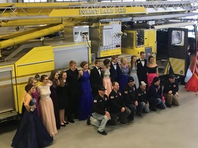 Students pose for prom pictures with firefighters from Forest Lake Fire Station 1 in Forest Lake, Minn. on Apr. 14, 2018.