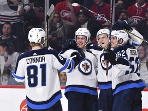 MONTREAL, QC - APRIL 03:  Sami Niku #83 of the Winnipeg Jets celebrates his first career NHL goal in his first game with teammates against the Montreal Canadiens at the Bell Centre on April 3, 2018 in Montreal, Quebec, Canada.  The Winnipeg Jets defeated the Montreal Canadiens 5-4 in overtime.  (Photo by Minas Panagiotakis/Getty Images)