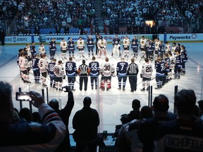 Jets and  Chicago Blackhawks players honour those involved in the Humboldt Broncos bus crash tragedy before NHL action on April 7, 2018 at Bell MTS Place on Saturday night. (Photo by Jason Halstead /Getty Images)
