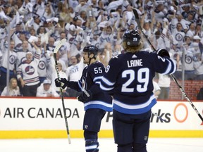 WINNIPEG, MANITOBA - APRIL 11: Mark Scheifele #55 and Patrik Laine #29 of the Winnipeg Jets celebrate Scheifele's goal against the Minnesota Wild in Game One of the Western Conference First Round during the 2018 NHL Stanley Cup Playoffs on April 11, 2018 at Bell MTS Place in Winnipeg, Manitoba, Canada. (Photo by Jason Halstead /Getty Images)