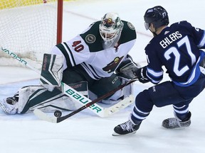 WINNIPEG, MANITOBA - APRIL 11: Devan Dubnyk #40 of the Minnesota Wild stops a breakaway attempt by Nikolaj Ehlers #27 of the Winnipeg Jets in Game One of the Western Conference First Round during the 2018 NHL Stanley Cup Playoffs on April 11, 2018 at Bell MTS Place in Winnipeg, Manitoba, Canada. (Photo by Jason Halstead /Getty Images)
