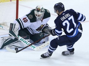 WINNIPEG, MANITOBA - APRIL 11: Devan Dubnyk #40 of the Minnesota Wild stops a breakaway attempt by Nikolaj Ehlers #27 of the Winnipeg Jets in Game One of the Western Conference First Round during the 2018 NHL Stanley Cup Playoffs on April 11, 2018 at Bell MTS Place in Winnipeg, Manitoba, Canada. (Photo by Jason Halstead /Getty Images)