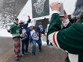 Fans take photos as they arrive at Xcel Energy Center before Game 3 between the Minnesota Wild and the Winnipeg Jets on Sunday.