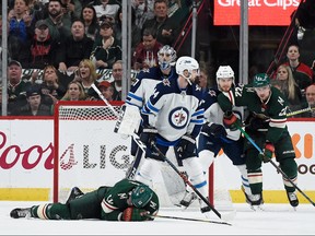 Eric Staal of the Minnesota Wild lays on the ice after a check by Winnipeg Jets defenceman Josh Morrissey during the first period in Game 4. Morrissey served a one-game suspension for the hit.