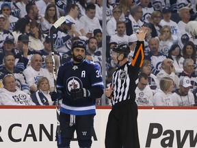Dustin Byfuglien (33) of the Winnipeg Jets chats with a referee during a break in play against the Minnesota Wild in Game 5 on Friday.