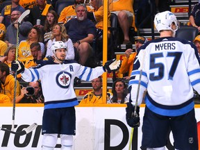 Mark Scheifele of the Winnipeg Jets celebrates with teammate Tyler Myers after scoring a goal against the Nashville Predators during the second period in Game 1.