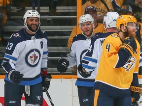 Jets defenceman Dustin Byfuglien (far left) had a goal and an assist and had a team-high 35:27 of ice time, finishing with six shots on goal, nine shot-attempts, three hits and four blocked shots in Game 2 against the Predators.
