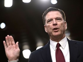 In this file photo taken on June 8, 2017, Former FBI Director James Comey takes the oath before he testifies during a US Senate Select Committee on Intelligence hearing on Capitol Hill in Washington, DC.