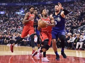 Toronto Raptors guard Kyle Lowry drives past Orlando Magic centre Nikola Vucevic on April 8.