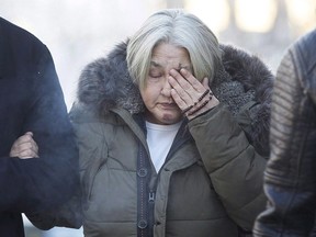 Thelma Favel, Tina Fontaine's great-aunt and the woman who raised her, weeps as she enters the law courts in Winnipeg the day the jury delivered a not-guilty verdict in the second degree murder trial of Raymond Cormier on Feb. 22. The woman who raised Tina Fontaine wants changes to Manitoba's child welfare system to prevent chronic runaways from ending up in grave danger.