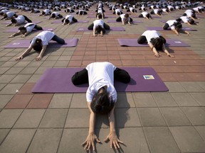 As the first yoga studio prepares to open in a southwestern Manitoba community a letter is spreading warning of its anti-Christian values. Participants strike a pose during a group yoga session at a park in Beijing, Saturday, June 18, 2016.