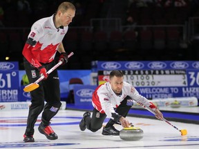 Canada skip Brad Gushue delivers his shot as lead Geoff Walker looks on as they take on South Korea at the men's world curling championship in Las Vegas on April 3, 2018