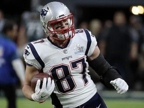 In this Feb. 4, 2018, photo, New England Patriots tight end Rob Gronkowski (87) warms up before Super Bowl 52 in Minneapolis. (AP Photo/Chris O'Meara)