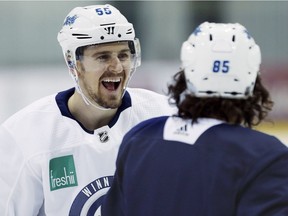 Winnipeg Jets centre Mark Scheifele (55) and centre Mathieu Perreault (85) joke during practice in Winnipeg on Monday, ahead of their opening playoff round against the Minnesota Wild.