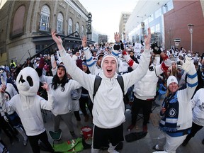 Winnipeggers attend the "White Out Street Party" for Winnipeg Jets game two NHL playoff action against the Minnesota Wild in Winnipeg on Friday, April 13, 2018.