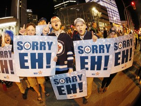 Winnipeg Jet fans celebrate at Portage an Main in downtown Winnipeg after the Winnipeg Jets defeated the Minnesota Wild in Game 5 Friday to win the first round 4-1.