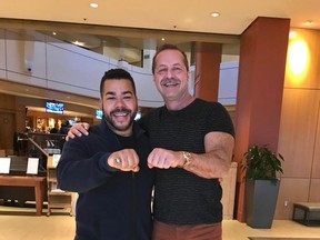 Milson Jonesís son, Devon, left, displays his fatherís 1987 Grey Cup championship Edmonton Eskimos ring alongside Ottawa businessman Walter Pamic, who bought it at an auction in the mid-1990s and has since returned it to the Jones family at no cost. (Supplied photo)