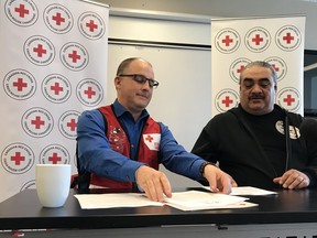 Shawn Feely of the Red Cross and James Favel of the Bear Clan announce a collaborative agreement between their organizations.