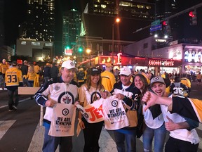 A group of Jets fans celebrates on Nashville's famous Broadway music district, while a Predators fan gives the thumbs down on Friday night.