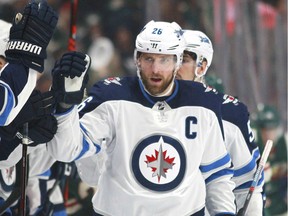 Winnipeg Jets forward Blake Wheeler (26) is congratulated after scoring a goal against the Minnesota Wild in the first period of an NHL hockey game on Sunday, April 15, 2018, in St. Paul, Minn.