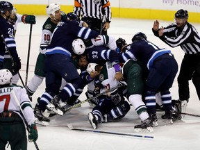 The Winnipeg Jets' and Minnesota Wild brawl after Winnipeg Jets' Bryan Little scored during third period NHL hockey action in Winnipeg on Nov. 27, 2017