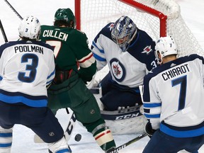 Winnipeg Jets goalie Connor Hellebuyck stops a scoring attempt by Minnesota Wild's Matt Cullen during the second period of Game 4 Tuesday,