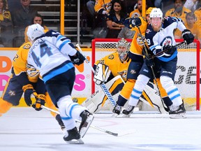 Jets sniper Patrik Laine tries to get in front of Predators goalie Pekka Rinne as Winnipeg’s Josh Morrissey takes a shot during Game 1 last night. (Getty Images)