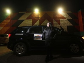 Christine Brouzes, a co- director of Ikwe Safe Rides - Women Helping Women, waits outside Winnipeg's notorious Main Street hotels recently. IKWE Safe Rides, a not for profit, has volunteer drivers connect with women needing rides through a Facebook group. In the last 30 days, they've given more than 3,000 rides.