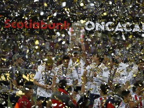 Chivas holds the trophy aloft as the celebrate winning the CONCACAF Champions League final soccer match in Guadalajara, Mexico, Wednesday, April, 25, 2018. Chivas defeated Toronto FC in a penalty shoot out. (AP Photo/Eduardo Verdugo) ORG XMIT: XEV140