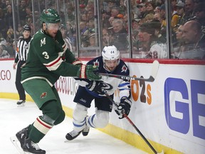 Minnesota Wild centre Charlie Coyle tries to stop Jets defenceman Josh Morrissey last night (AP)