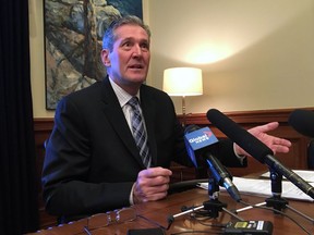 Manitoba Premier Brian Pallister speaks to reporters in his office in Winnipeg on Friday, April 6, 2018. Manitoba Premier Brian Pallister said Friday he will see the federal government in court if it imposed a higher carbon tax on Manitobans than Pallister's government is planning.