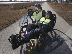 Jill Oaks and her husband Rick Riewe are photographed on a bike trail in Winnipeg, Wednesday, April 4, 2018. Riewe, an active senior biologist with Parkinson's, and Oaks, a university professor, are heading on a three-month long bike tour of a lifetime through Canada and the United States and are looking for a caregiver to help them. This may possibly their last big bike trip. THE CANADIAN PRESS/John Woods ORG XMIT: JGW203