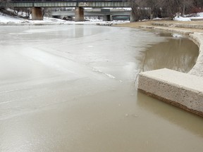 The Assiniboine River flooded its banks and covered the walkway near the Forks in Winnipeg, Man. Monday April 14, 2014. Brian Donogh/Winnipeg Sun/QMI Agency
