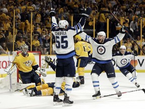 Jets centre Mark Scheifele (55) celebrates with Paul Stastny after scoring the tying goal against the Nashville Predators late in the third period to force overtime in Game 2 on Sunday. (The Associated Press)