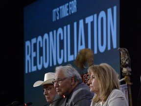 Commission chairman Justice Murray Sinclair (centre) and fellow commissioners Marie Wilson (right) and Wilton Littlechild discuss the commission's report on Canada's residential school system at the Truth and Reconciliation Commission in Ottawa on Tuesday, June 2, 2015. THE CANADIAN PRESS/Adrian Wyld   // 0603 na TRCmain
