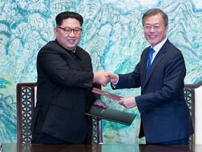 FILE - In this April 27, 2018 file photo, North Korean leader Kim Jong Un, left, and South Korean President Moon Jae-in shake hands after signing on a joint statement at the border village of Panmunjom in the Demilitarized Zone, South Korea. Seoul says North Korean leader Kim plans to shut down the country's nuclear test site in May and reveal the process to experts and journalists from the United States and South Korea. Seoul's presidential spokesman Yoon Young-chan said Sunday, April 29, Kim made the comments during his summit with South Korean President Moon Jae-in on Friday.(Korea Summit Press Pool via AP)