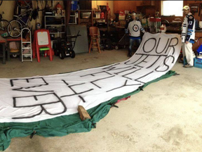 Jeremie Robin (left) and Chris Robin with the recreation of an iconic banner that was hung during the Winnipeg Jets final game in 1996.