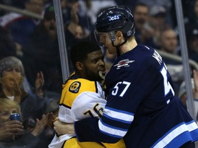 Winnipeg Jets defenceman Tyler Myers (right) pins Nashville Predators defenceman P.K. Subban to the boards in Winnipeg on Sun., March 25, 2018. Kevin King/Winnipeg Sun/Postmedia Network