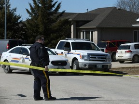RCMP investigate at a scene in Steinbach on Sun., April 1, where the bodies of a father and son were discovered on Saturday. The major crimes unit is investigating, but RCMP say there are not looking for any suspects and there's no threat to public safety. Kevin King/Winnipeg Sun/Postmedia Network