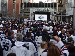 People crowd Donald Street for the Winnipeg Whiteout Street Party on Wed., April 11, 2018. A reader suggests the city spent too much money on the playoff party. Kevin King/Winnipeg Sun/Postmedia Network