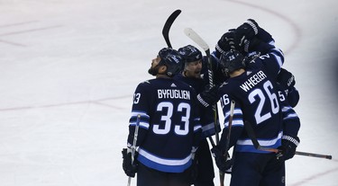 Winnipeg Jets centre Mark Scheifele (second left) celebrates his goal against the Minnesota Wild during Game 1 of their first-round NHL playoff series in Winnipeg on Wed., April 11, 2018. Kevin King/Winnipeg Sun/Postmedia Network