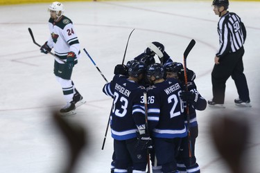 The Winnipeg Jets celebrate a goal from centre Mark Scheifele against the Minnesota Wild during Game 1 of their first-round NHL playoff series in Winnipeg on Wed., April 11, 2018. Kevin King/Winnipeg Sun/Postmedia Network